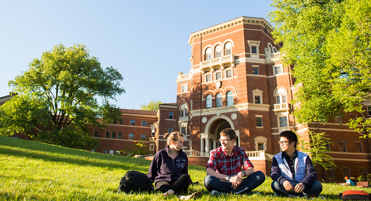 A group of students sit in the grass and relax on Oregon State's Corvallis campus.