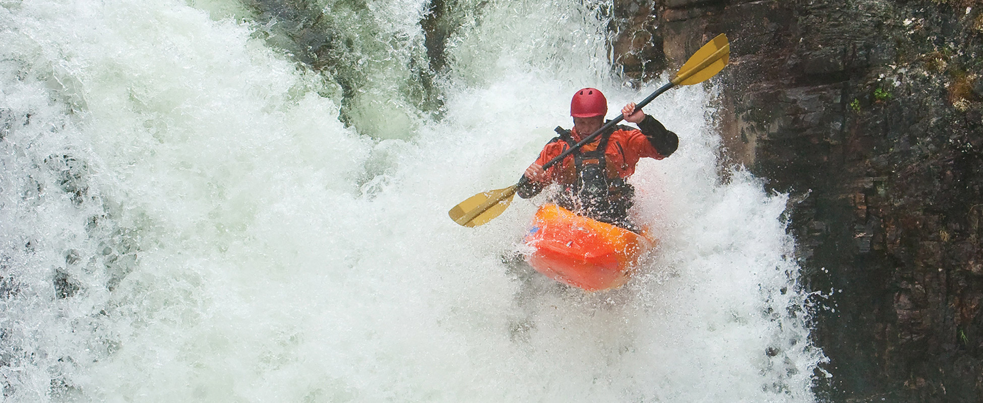 A kayaker navigates rapids.
